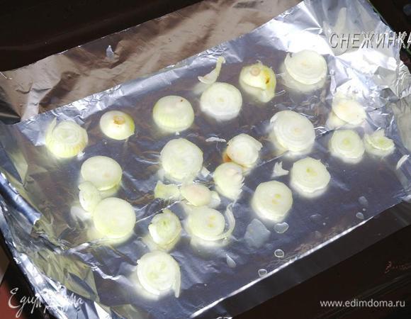 На противень стелим фольгу в 2 слоя, не отрывая. Небольшие луковички нарезаем кольцами и распределяем по фольге, формируем основание под нашу рыбку. Благодаря этому щука не прилипнет к фольге и не подгорит.
