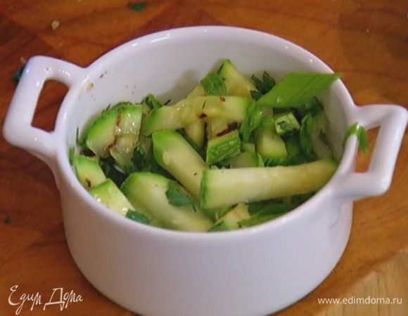 Две небольшие керамические формы смазать оливковым маслом, выложить в них кабачки с зеленью.