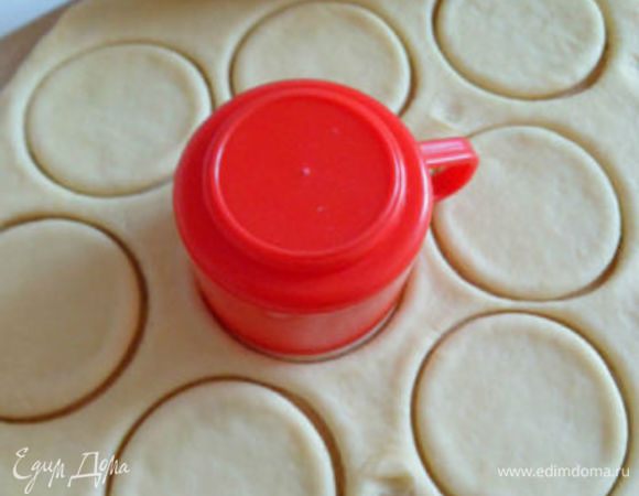 Тесто присыпать мукой и раскатать в пласт толщиной около 3-4 миллиметров.Кружкой вырезать из теста круги