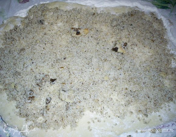 Полученное тесто я разделила на 4 части, решив, что раскатывать все сразу будет нелегко. Стол и руки лучше припудрить мукой.
Каждую часть раскатать тонким продолговатым пластом, смазать ореховой начинкой и свернуть рулетом.