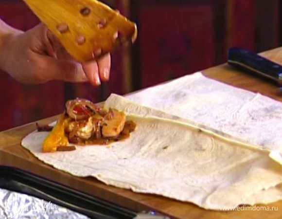 Лаваш разрезать на несколько частей, на каждую выложить индейку с луком, понемногу томатного соуса и сыра и свернуть рулетиками.