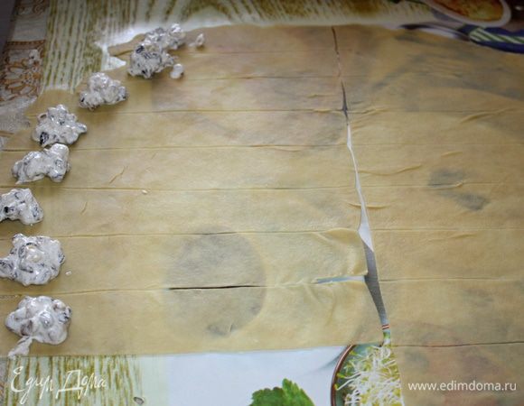 По внешнему краю лент выложить начинку, примерно по чайной ложечке.