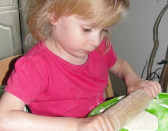 А дочка делает колобка.