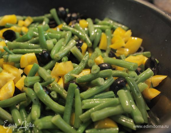 Когда фасоль начнет становиться более мягкой, добавляем порезанные пополам маслины без косточек и сладкий перец, порезанный кубиками. Солим и перчим, можно добавить немного соевого соуса. Тушим под крышкой еще 10 минут.