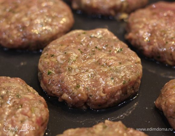 Смажьте котлеты растительным маслом сверху. Так вы удержите влагу внутри котлет. Поставьте противень в предварительно разогретую до 210°C духовку на 10 минут. Затем снизьте температуру до 180°C и готовьте еще 20 минут. Котлеты будут готовы. Если хотите, включите верхний гриль на максимальную температуру минуты на 2 — так вы добьетесь корочки.