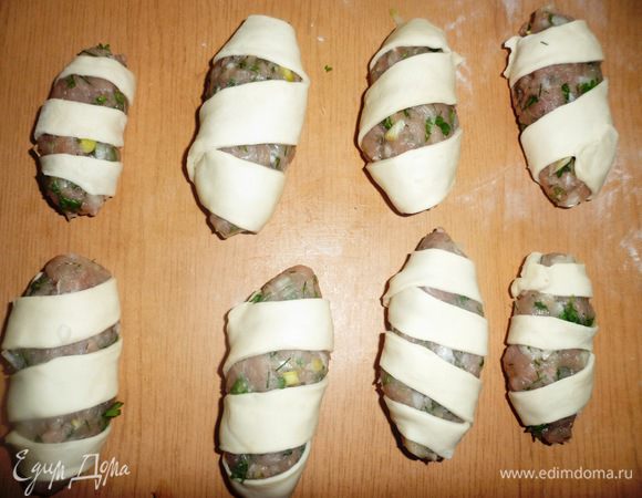 Обмотать каждую колбаску тестом, чтобы получилась спираль