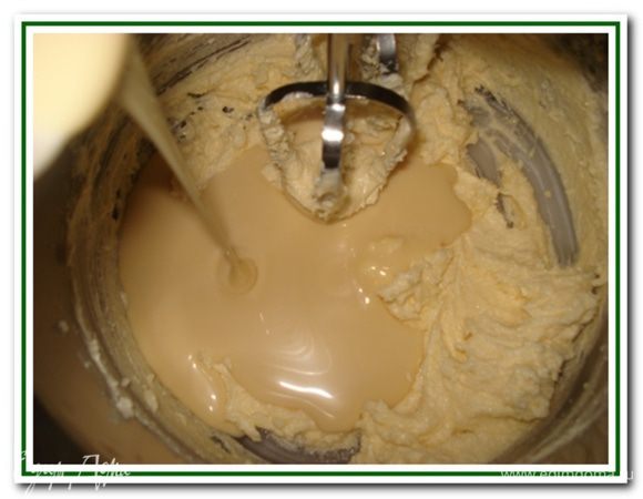 Продолжая взбивать, влить тонкой струйкой сгущенку.