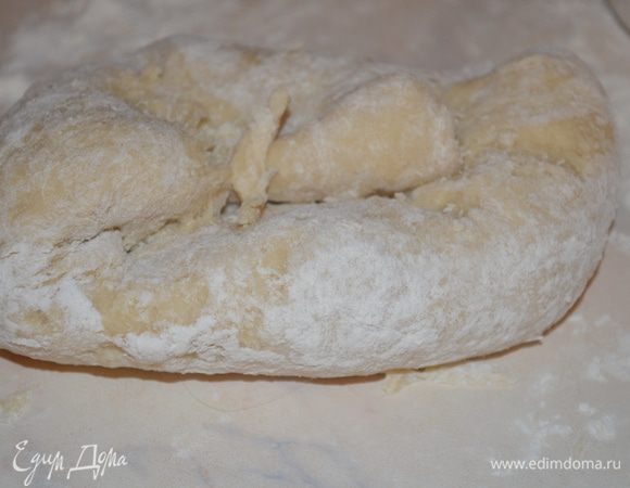 Стол припылить мукой и выложить на него тесто. Вымешивать тесто примерно 10 минут до эластичного состояния. Оно не должно липнуть к рукам и столу.