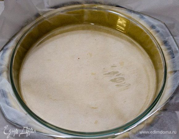 Для того чтобы тесто не расплылось в духовке, нужно накрыть его пергаментом и засыпать горохом-фасолью. Мой опыт: к сожалению, у меня не всегда в доме есть горох или фасоль, поэтому я придумала, чем придавить его :) Думаю, сейчас почти у всех есть стеклянная посуда для микроволновки. Так вот я подобрала стеклянную крышку от емкости, как раз подходящую по диаметру. Ей и прижимаю тесто.