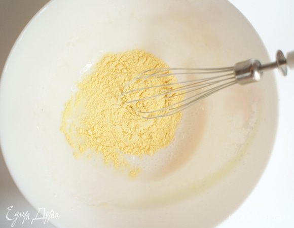 Продолжая взбивать, всыпать кукурузную муку.