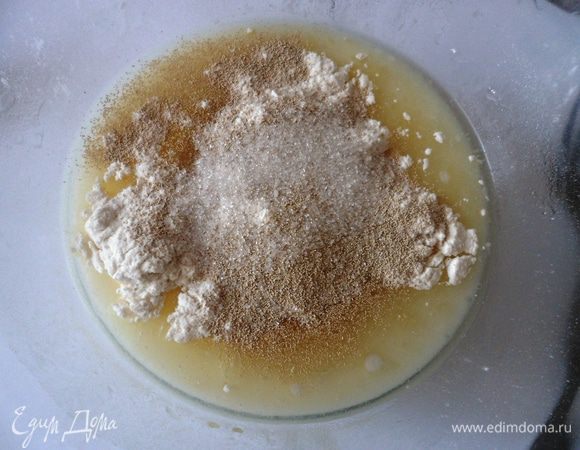 Добавьте немного муки и дрожжи, перемешайте, дайте постоять 2–3 минуты.