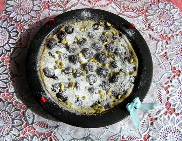 Клафути украсить ягодами, посыпать сахарной пудрой и рубленными фисташками. Подавать теплым.