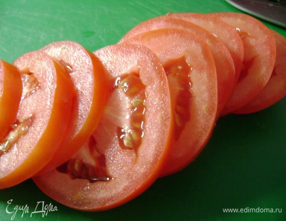 Помидор нарезать тонкими ломтиками.