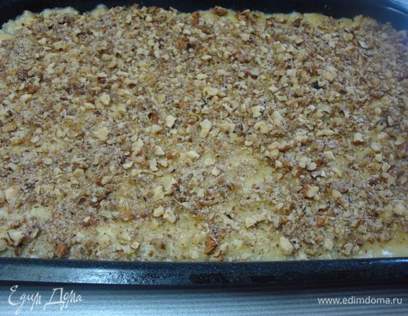 Тесто раскать в прямоугольник, выложить на смазанный маслом противень. Наколоть тесто вилкой. Выложить ореховую смесь.