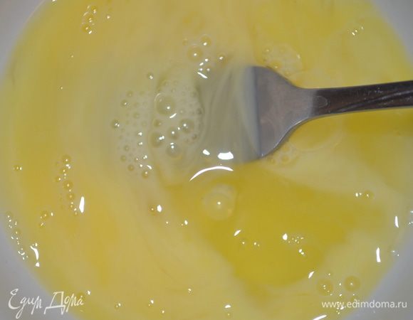 В отдельной миске слегка взбить вилочкой яйца