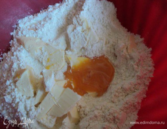 Для песочного теста смешать муку, сахар, соль, добавить порезанное мелкими кусочками масло, желток и ледяную воду. Быстро замесить тесто.