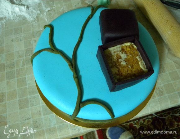 Обтянуть сам торт мастикой. Сделать веточки под сакуру и уложить коробочку под кольцо. 