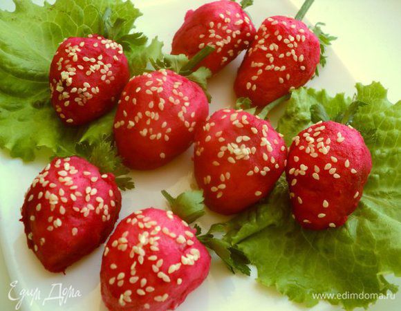 Из петрушки сделать чашелистики, из лука – хвостики. Смазать «клубнички» оливковым маслом при помощи кисточки и посыпать кунжутом.