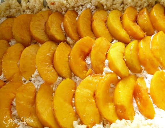 С персиков снять кожицу, удалить косточки и нарезать дольками. Выкладываем слой персиков.