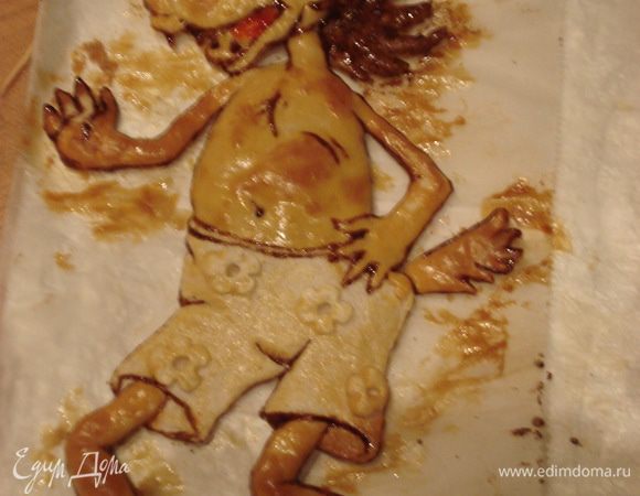 Готового "волка" смазываем желтком и ставим в разогретую до 180 гр. духовку и выпекаем до готовности. Запеченному  "волку" даем остыть  и раскрашиваем его сахарной глазурью (белок + сахарная пудра), смешанной с пищевыми красителями и корицей.