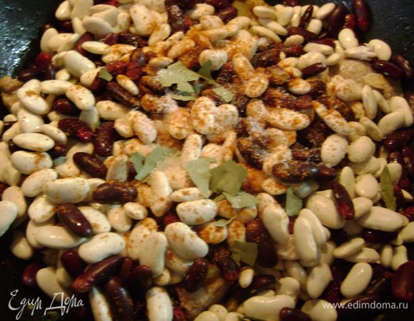 Перчик чили очистить от семян и мелко нарезать, разложить поверх фасоли. Туда же положить лавровый лист.