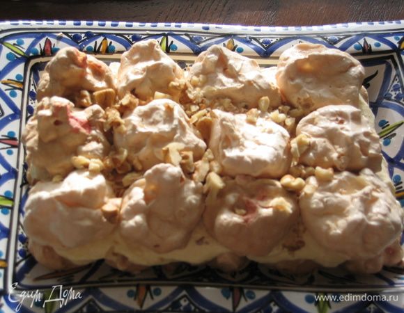 Выложить второй ярус меренгами, посыпать орехами и смазать кремом.