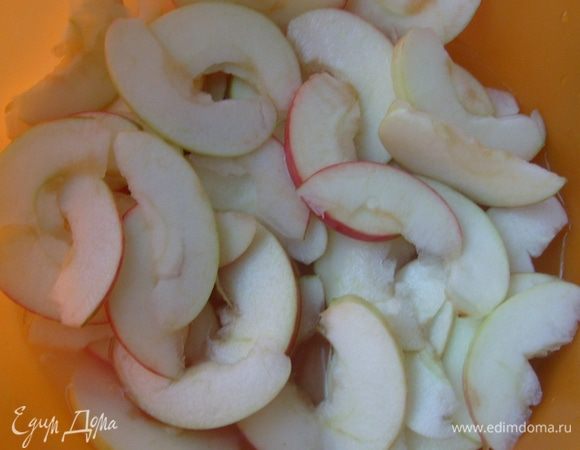 Яблоки желательно взять достаточно крепкие. Можно использовать яблоки разных сортов, так пирожные получатся более изысканными.
Яблоки помыть, вырезать сердцевину и нарезать тонкими ломтиками. Здесь нужно, чтобы яблоки были действительно нарезаны тоненькими ломтиками.
В миске развести лимонный сок со 100 мл холодной воды. Выложить порезанные яблоки в разведенный лимонный сок. Можете просто сбрызнуть яблоки лимонным соком, так как данная операция нужна только для того, чтобы яблоки не почернели.