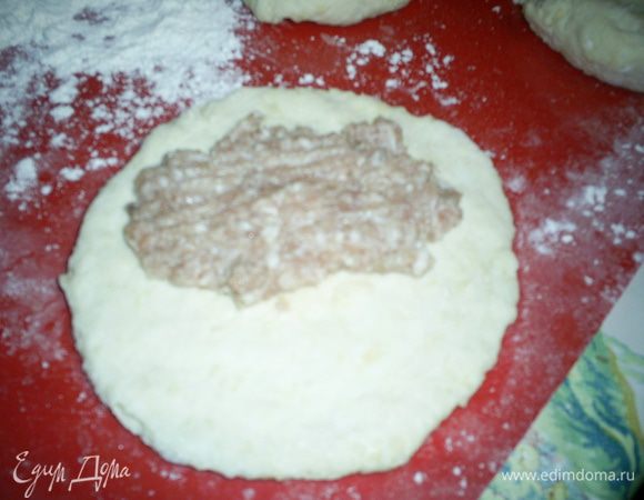 Делим тесто на шесть частей. Каждую раскатываем в лепешку толщиной меньше 5мм. Я просто разминала тесто руками, оно очень податливое и держит форму. Рабочую поверхность и руки надо припудрить мукой. На один край лепешки выкладываем начинку, распределяем ее по одной половине, не доходя 0,5см до края, сворачиваем и защипываем края.