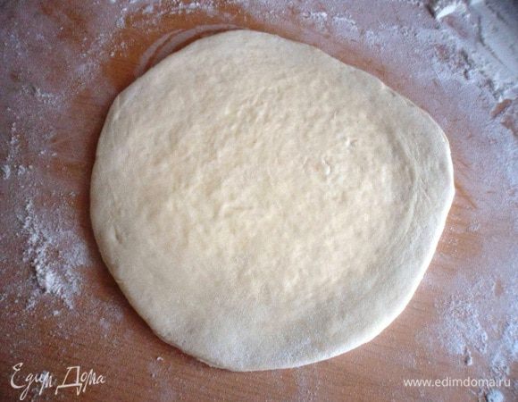 Закрепить края лепешки и раскатать в тонкий пласт,