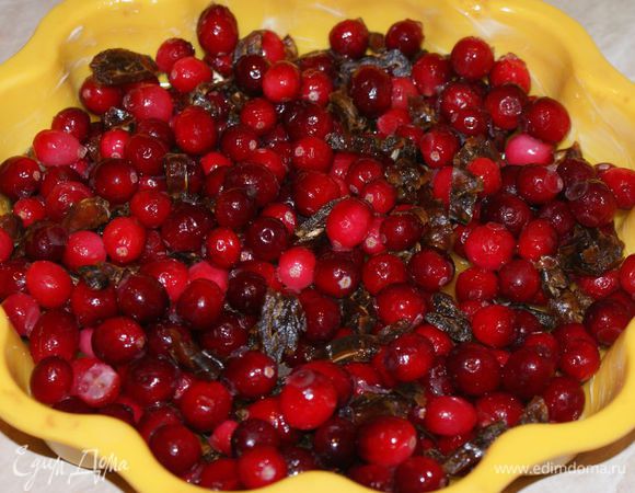 Финики очистить от косточек и мелко нарезать. Сверху карамели выложить клюкву и финики.