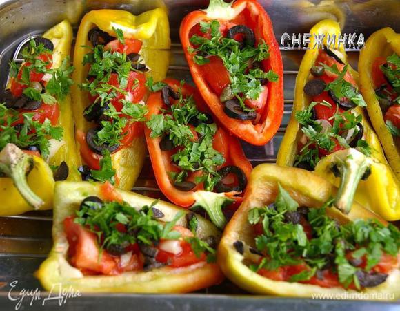 На половинки перцев укладываем дольки помидор, затем чеснок, маслины, по 2 каперса. Присыпать немного рубленой петрушкой.