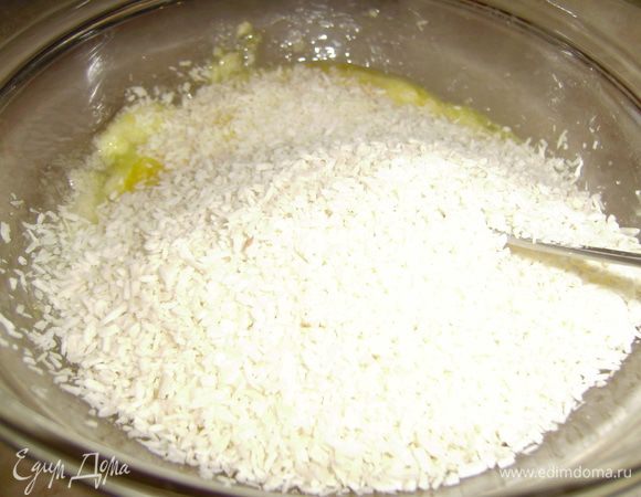 Затем добавьте кокосовую стружку и тщательно перемешайте.