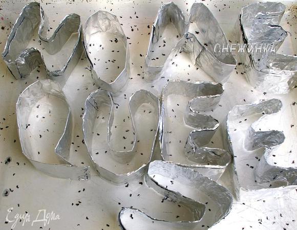 Теперь приступим к самому интересному)) Итак, фольгу разматываем на длину, достаточную на одну букву. Дальше отматываем фольгу еще такой же длинны и складываем пополам. Эту длинную, но широкую полоску складываем, загибая 2 раза. Ширины 1 листа хватает на 2 буквы. Таким образом получается достаточно прочная неширокая полоска. Из нее складываем букву, концы  чтобы держались, я прошила немного ниткой. Так «лепим» все необходимые буквы. Получается вот так)) 