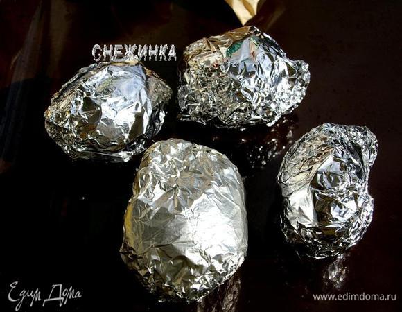 Каждую картофелину заворачиваем в фольгу, сложенную в два слоя, кладём на противень. Ставим запекаться около 30 минут. Готовность проверяем зубочисткой.