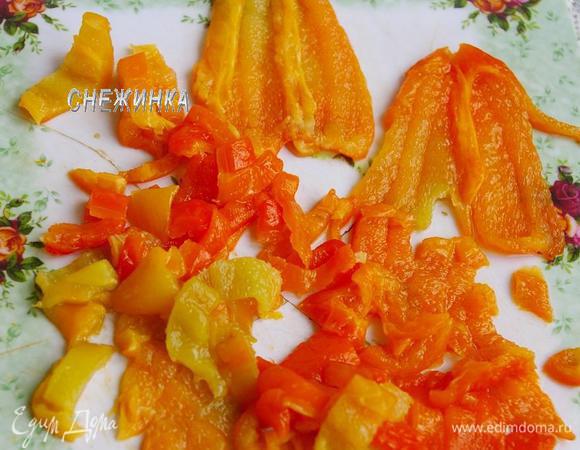 Когда перец готов, кладем его на тарелку и закрываем плотно пищевой пленкой. Даем перцу «попарится». Затем легко снимаем кожицу, удаляем семена, а мякоть нарезаем соломкой.