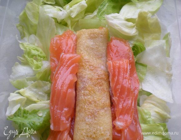 В форме определить примерно центр туловища. Положить дольки лосося, омлета. 