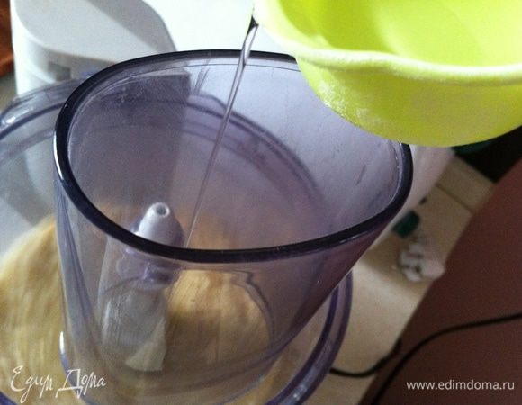 Не прекращая помешивать, вливать понемногу воду. Я делала тесто достаточно рассыпчатое. Если хотите, чтобы оно было более эластичным, добавьте еще немного воды.