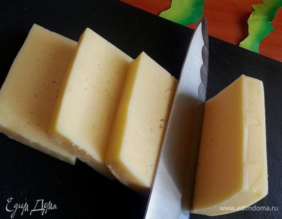 Берём кусочек сыра и делим его острым ножом на 4 толстые части.