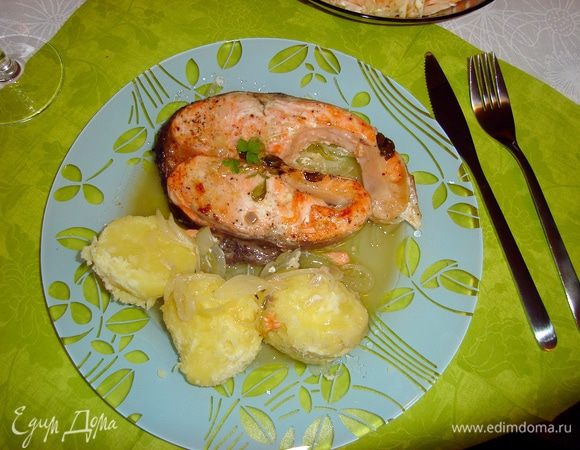 Подавайте форель с вашим любимым гарниром. У меня — в стиле домашнего обеда — отварной рассыпчатый картофель. Полейте его выделившимся при запекании рыбы соком, он прекрасно заменит соус, рядом положите лук.