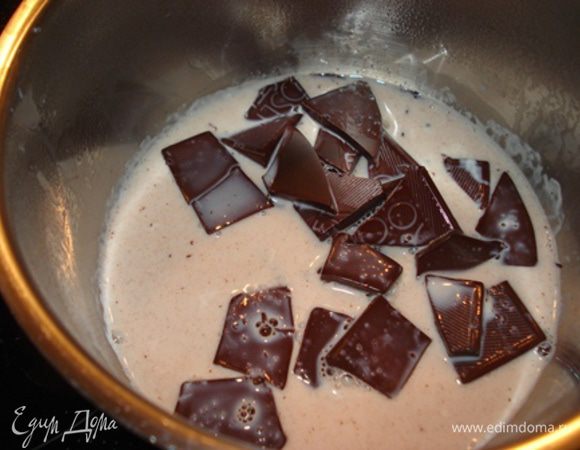 Молоко довести до кипения, снять с огня. Добавить шоколад, перемешать, чтобы шоколад полностью растаял.