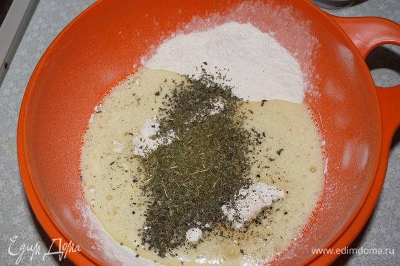 Вылить масляно-яичную смесь в муку. Добавить травы, тмин, соль, перец...