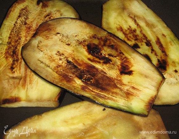 Баклажан нарезать пластинками примерно 1 см в толщину. Обжарить, смазав с двух сторон оливковым маслом.Помидоры и моцареллу нарезать кружочками.