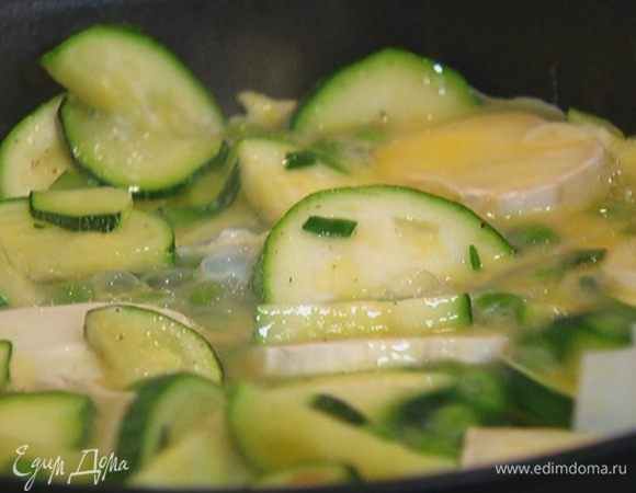 Выложить сыр на цукини с горошком, залить яйцами и отправить в разогретую духовку на 10 минут.