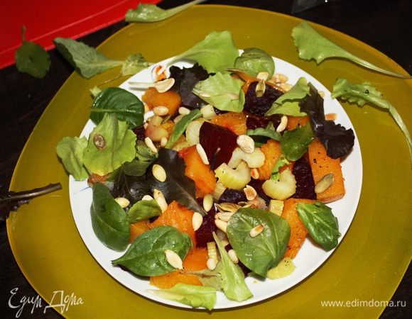 Немного остудим овощи. Режем свеклу такими же кусочками,как нарезана тыква. Выкладываем на тарелку овощи,присыпаем листьями салата и посыпаем орешками.
