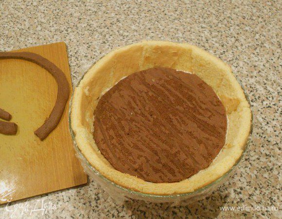У коричневого коржа обрезать по периметру подсохший край и плотно уложить его в миску. Прижмите слегка, чтобы не оставалось пустот. Необходимый диаметр коржа можно подобрать по какой-нибудь крышке от кастрюли.