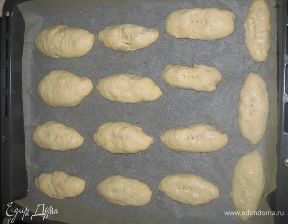 У нас сформировались куколки бабочек. Мы их аккуратно швом вниз перекладываем на застеленный пекарной бумагой противень, оставляя место для подъема теста.