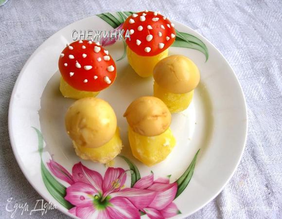 На картофельные «ножки» надеваем «шляпки» из яиц и помидора. Для «мухоморчиков» майонезом делаем точечки.