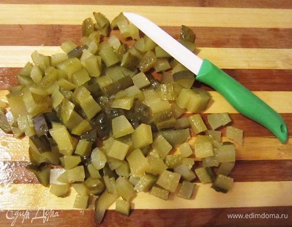 Нарежьте соленые огурцы, немного припустите.