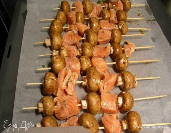 На деревянные шпажки нанизываем по очереди кусочки рыбы и грибы. Отправляем в духовку 180-200 гр минут на 20. В оригинале автор готовила их в режиме гриль, тогда их нужно периодически переворачивать и немного смазывать маринадом или маслом. Я готовила просто в режиме верх-низ, побоялась рыбу пересушить. В следующий раз попробую гриль. 
