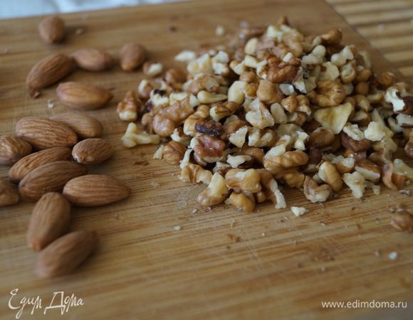 Изюм ошпарить кипятком, орехи порубить